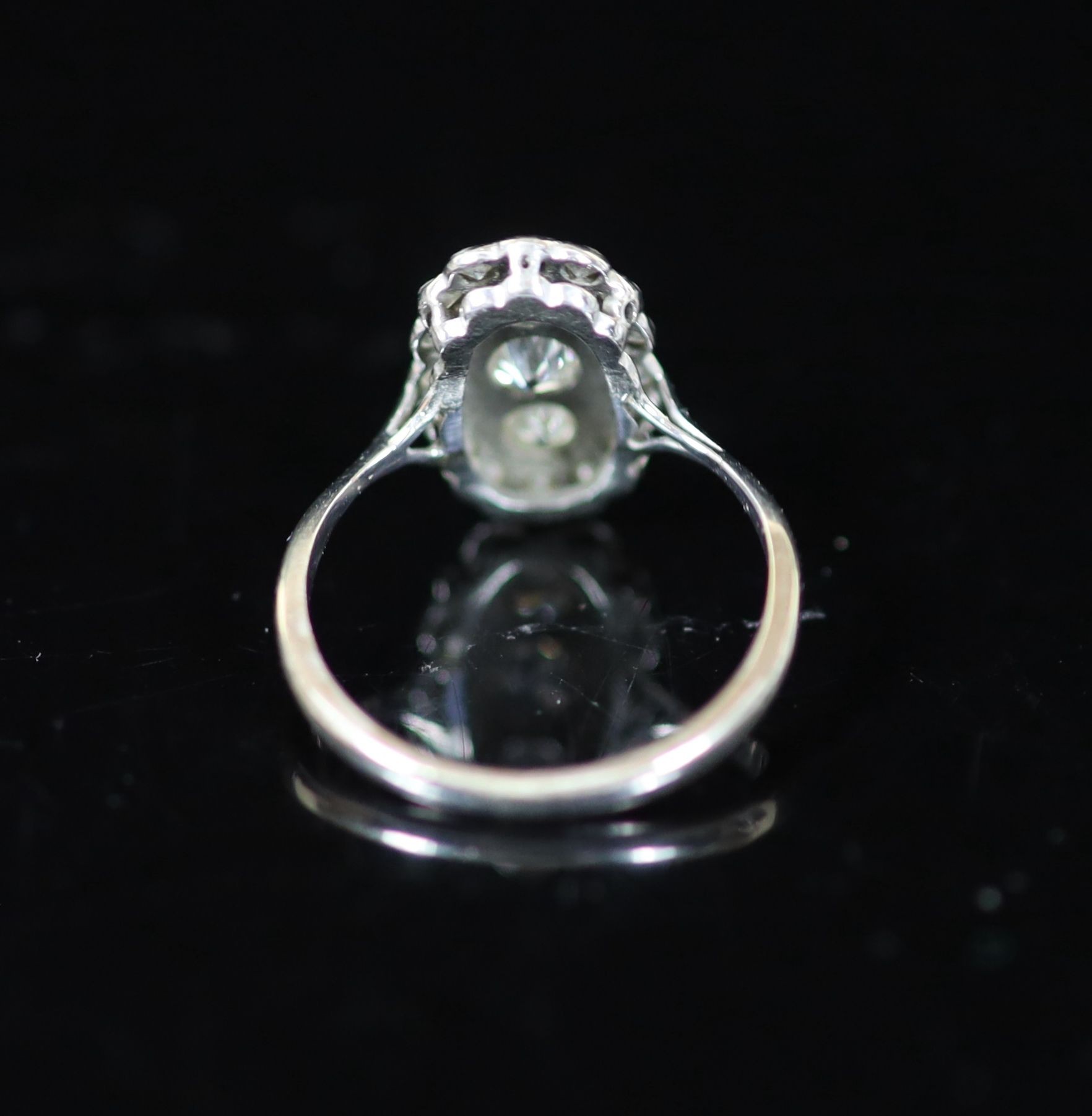 A 1940's 18ct white gold and diamond set oval cluster ring